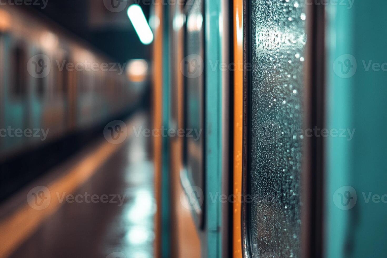 A train is seen through the window of a subway station photo