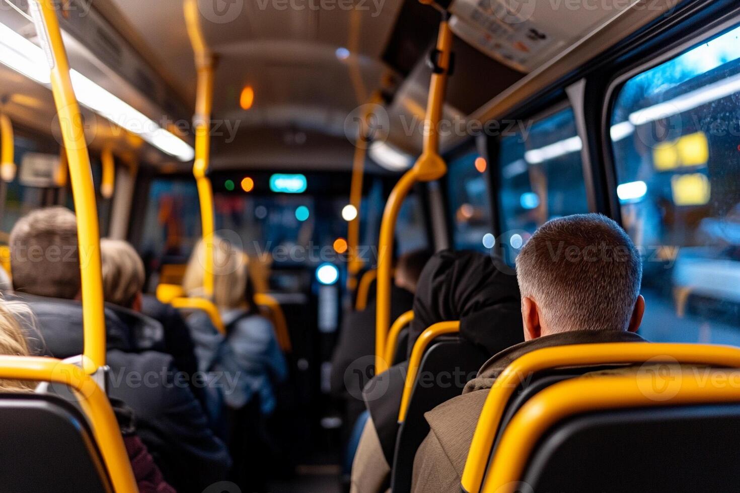 People are sitting on the bus at night photo