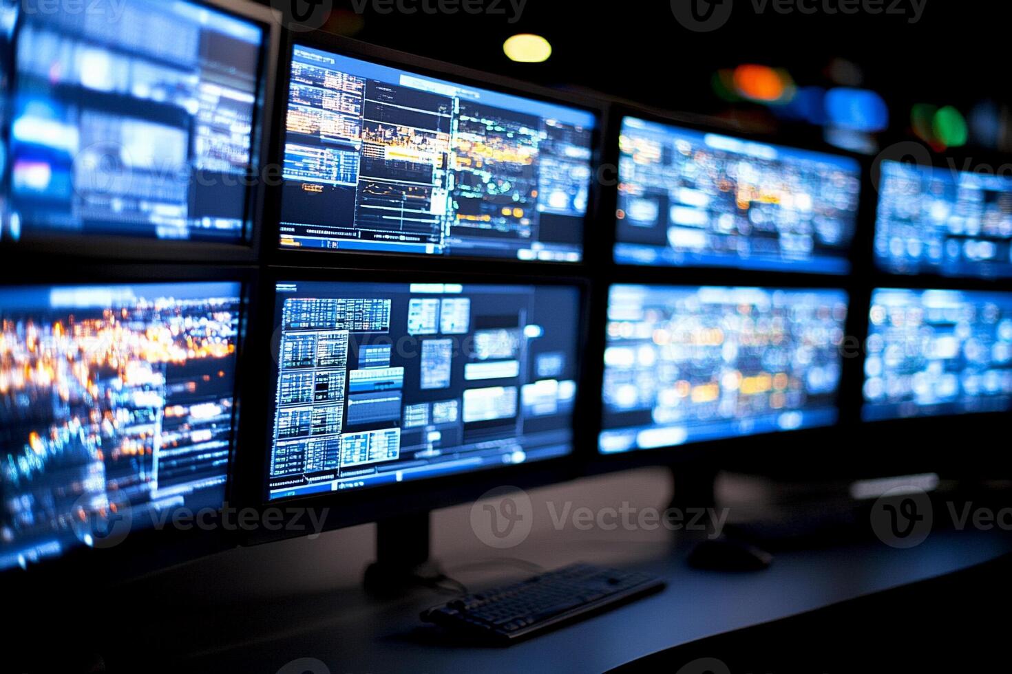 A group of monitors with multiple screens on them photo