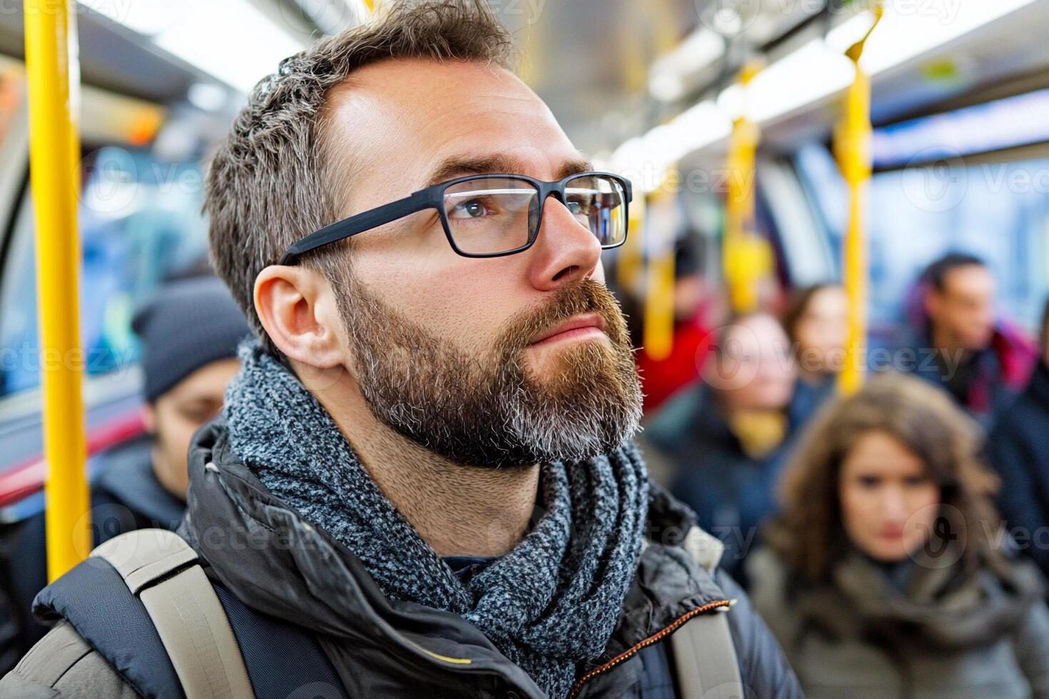 A man with glasses and beard on a bus photo