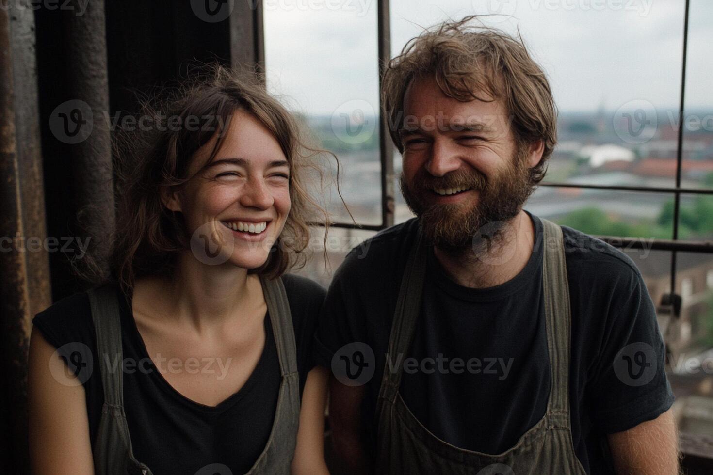 A man and woman smiling in front of a window photo