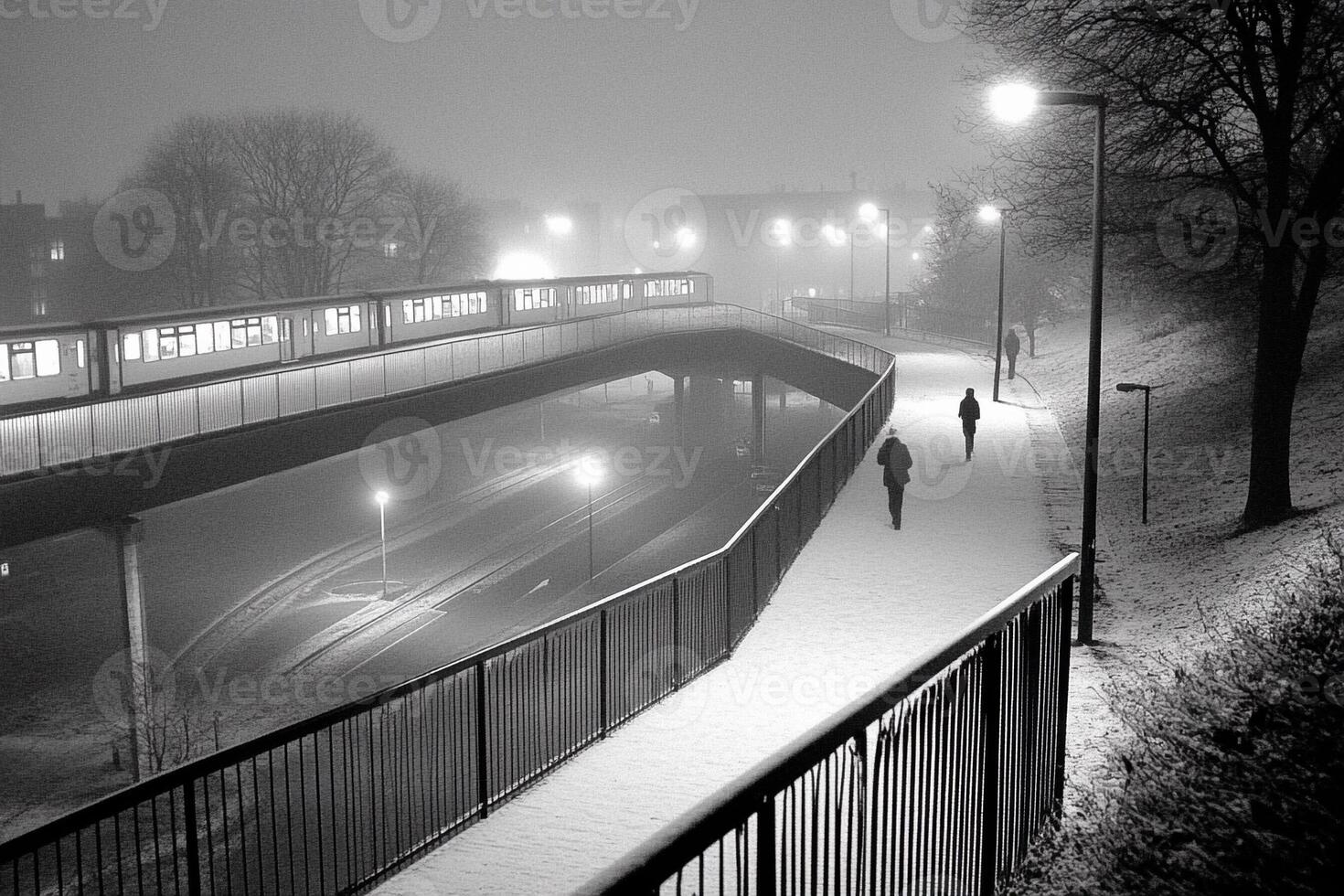 A black and white photo of a train on a foggy night