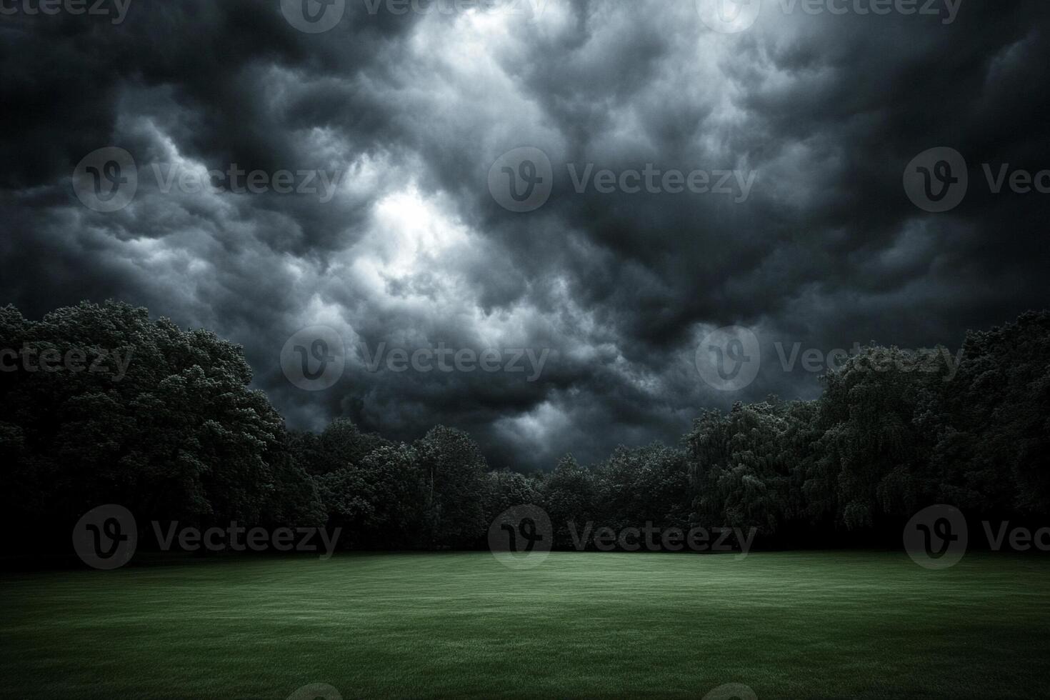 Dark stormy sky over a green field photo
