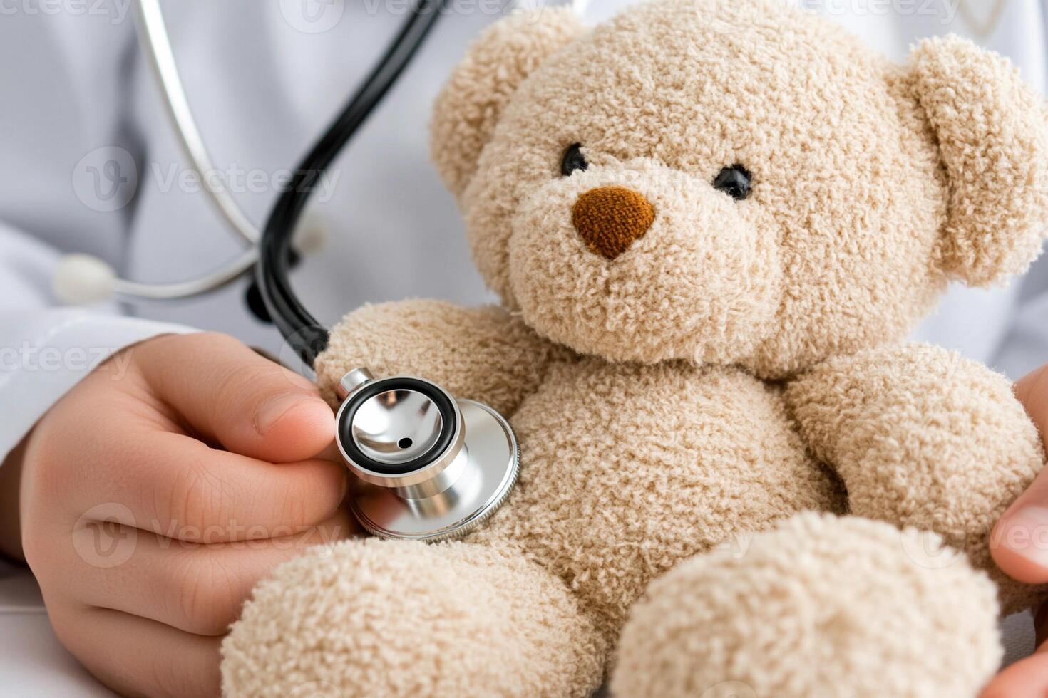 A doctor's hands holding a teddy bear photo