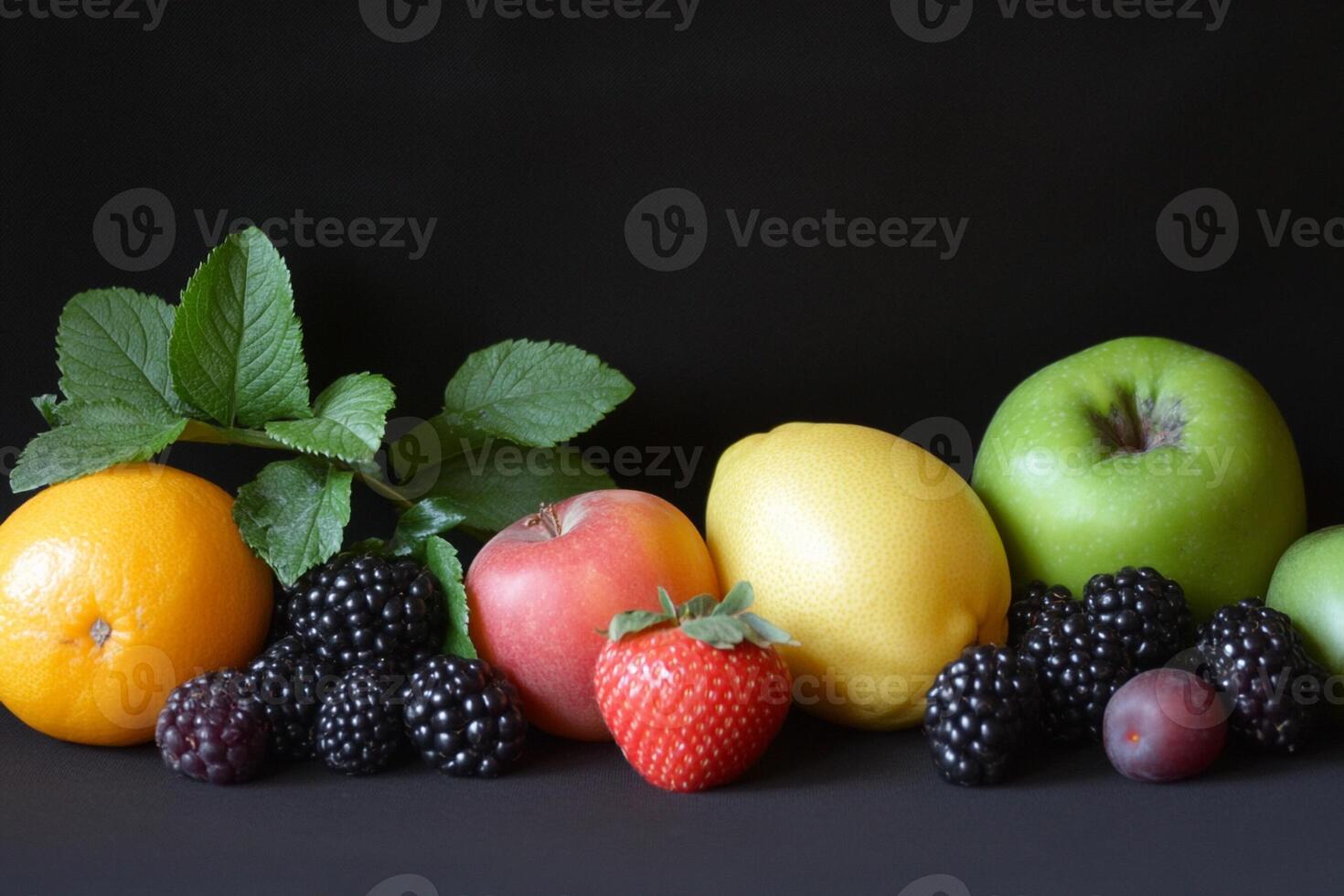 A group of fruits including apples, oranges, berries, and a blackberry photo