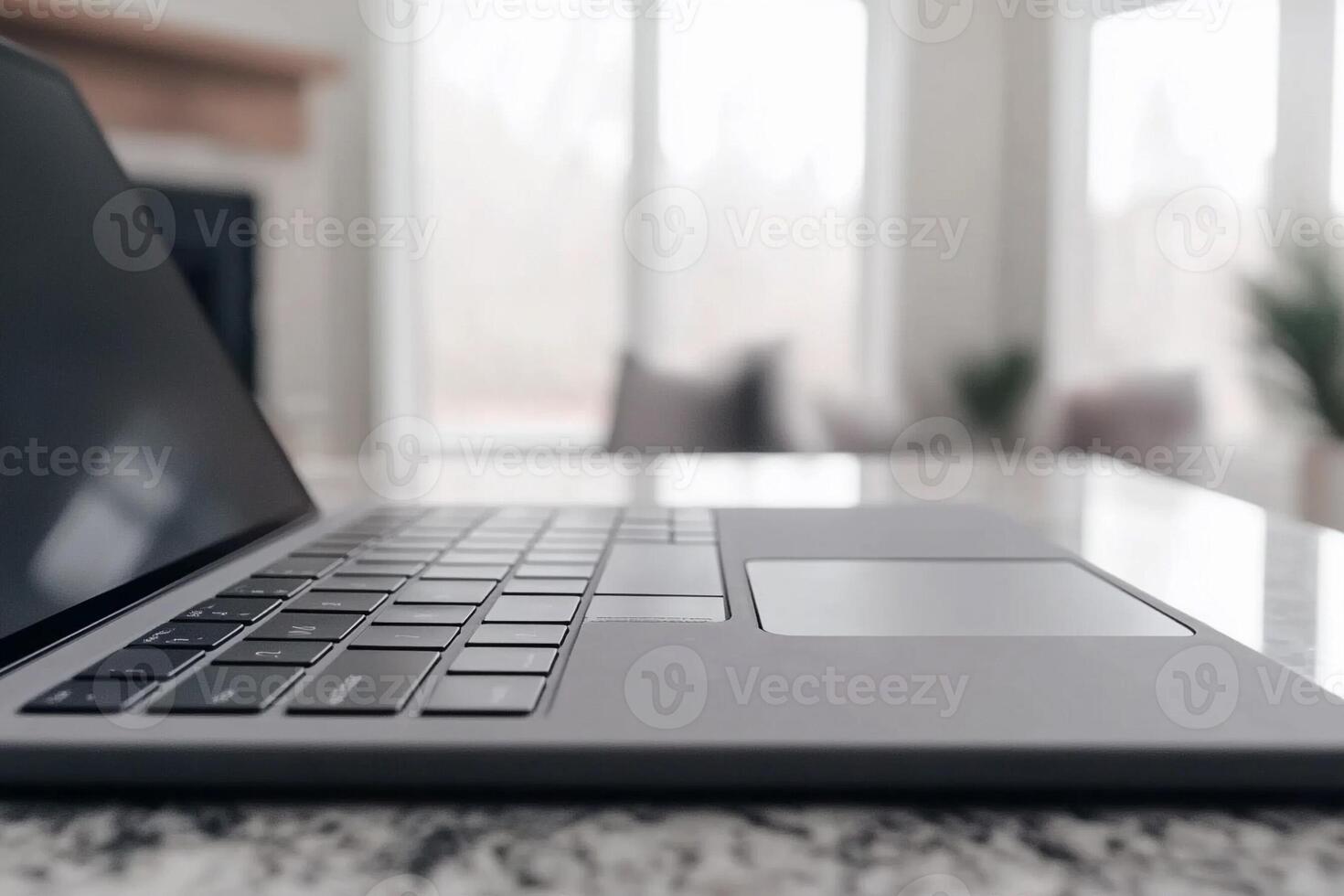 A laptop is sitting on a table in front of a fireplace photo
