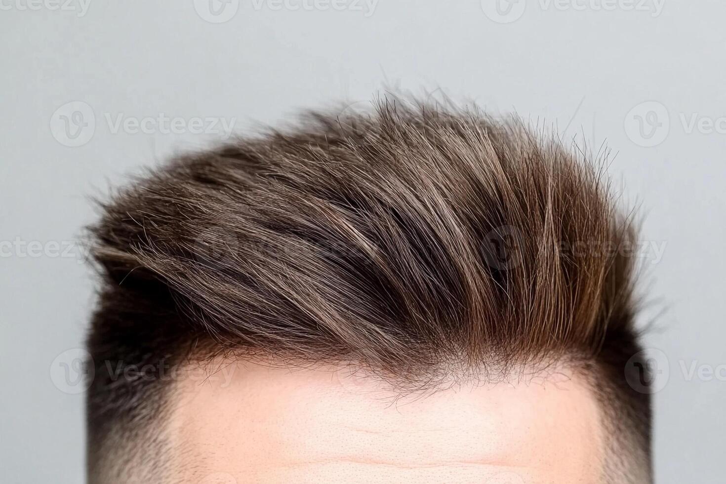 A man with a mohawk and a shaved head photo