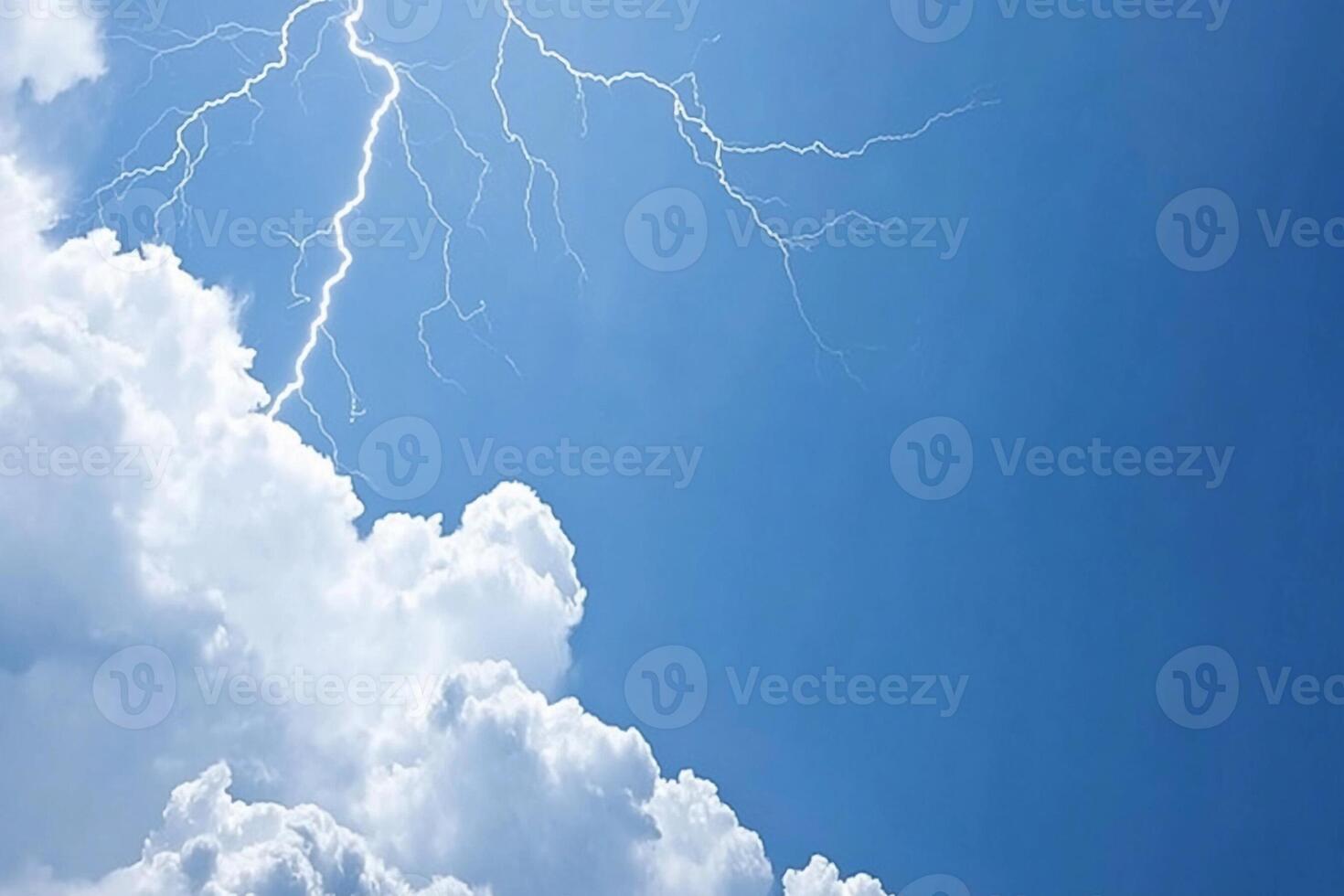 A lightning bolt is seen in the sky above a cloud photo
