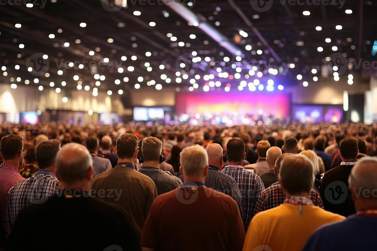 A large crowd of people in a convention hall photo