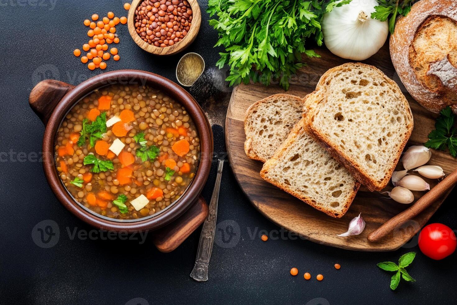 Lentil soup with bread and vegetables on a dark background photo