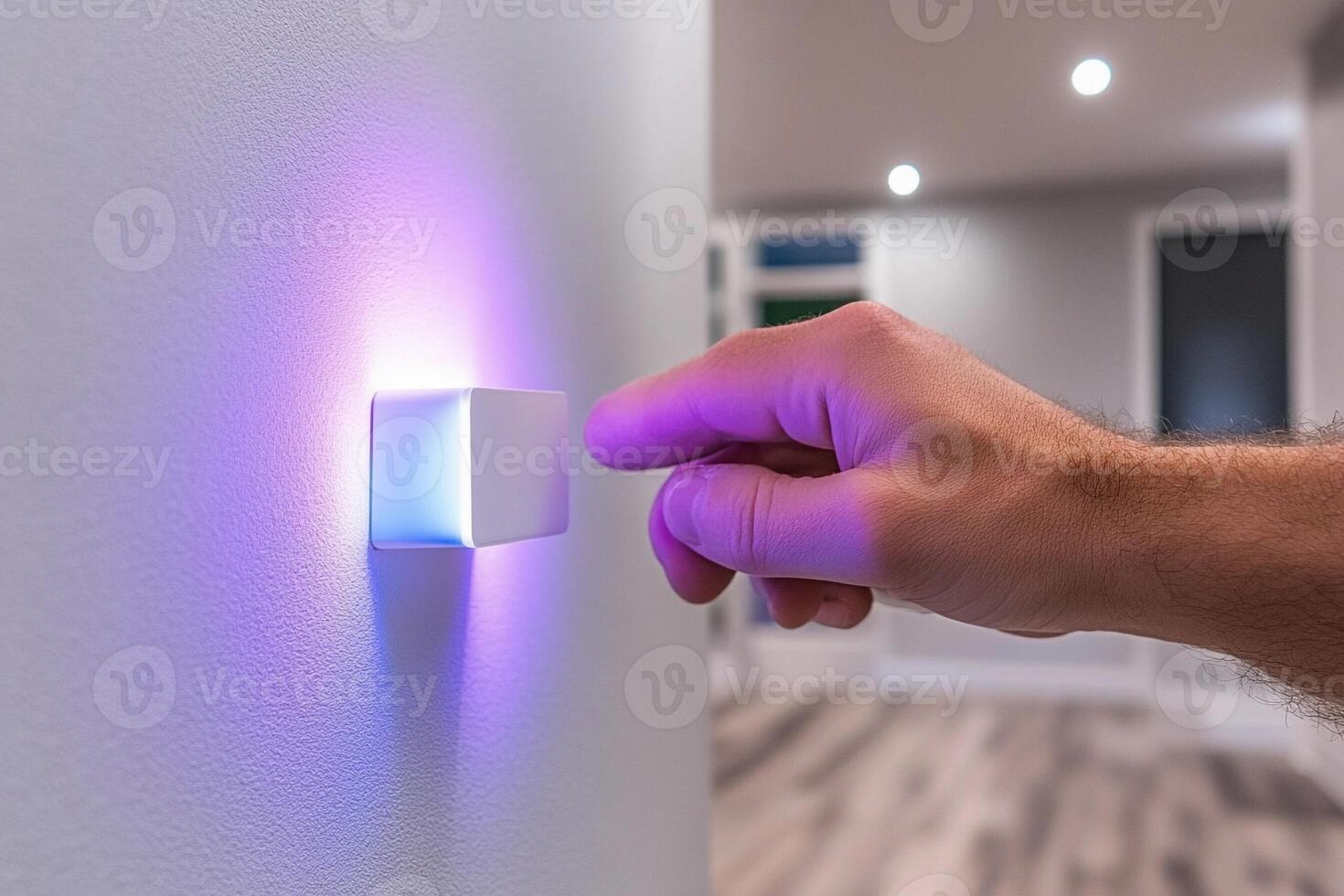 A person is turning on a light switch with a purple light photo
