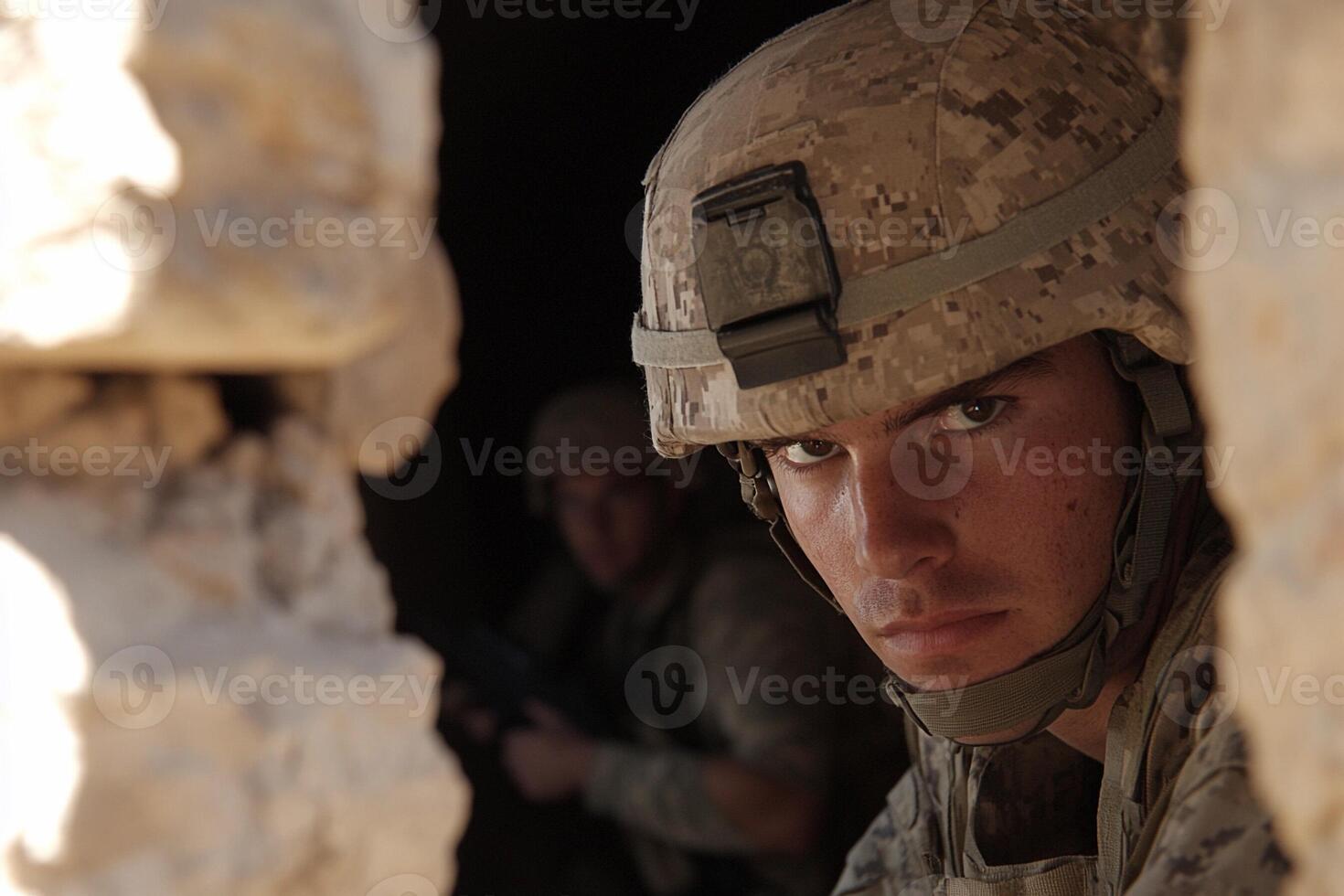 A soldier is looking out from a tunnel photo