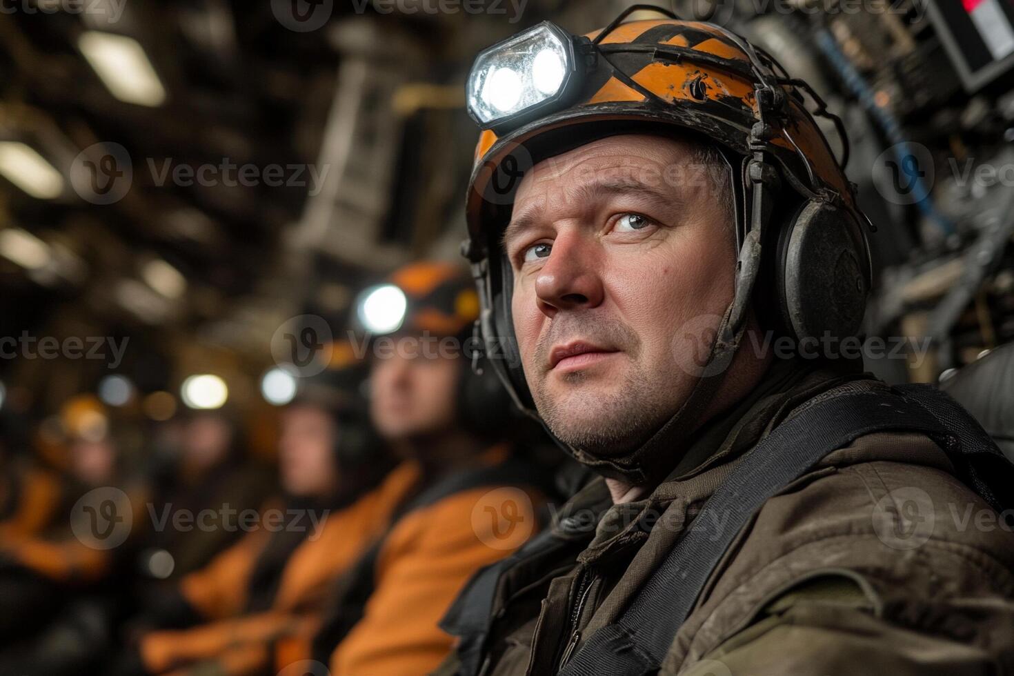 A man in a helmet sitting in a military plane photo