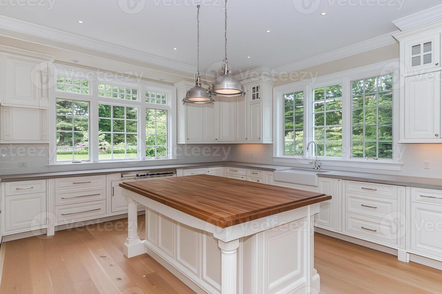 A large kitchen with white cabinets and wooden counter tops photo