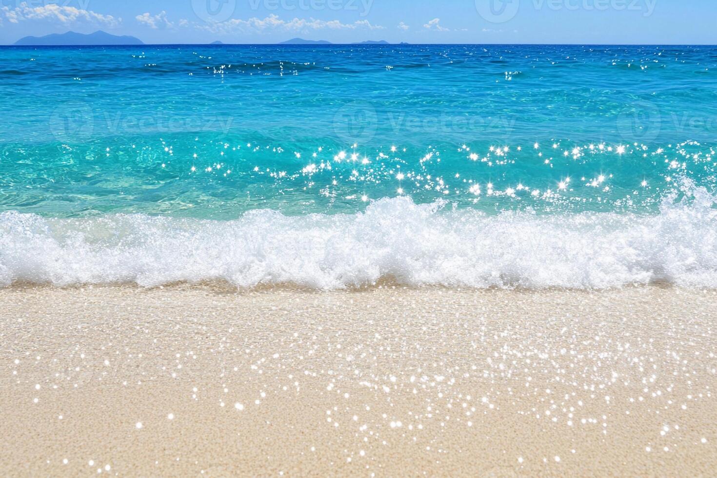 A sandy beach with waves and a blue ocean photo