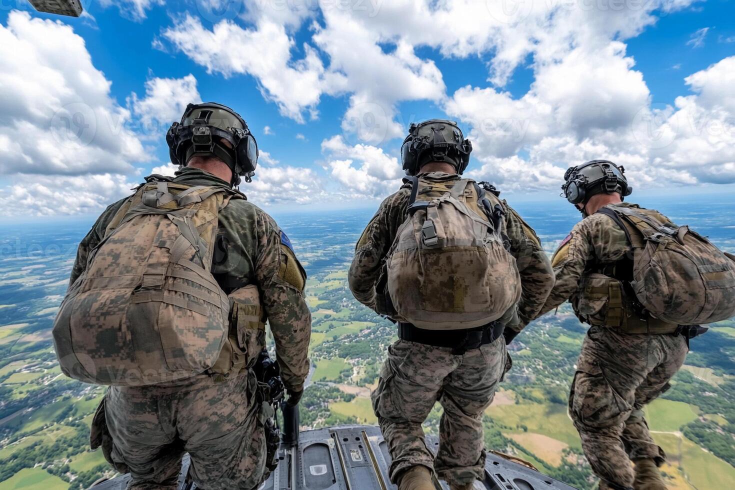 Three soldiers standing on the side of a helicopter photo