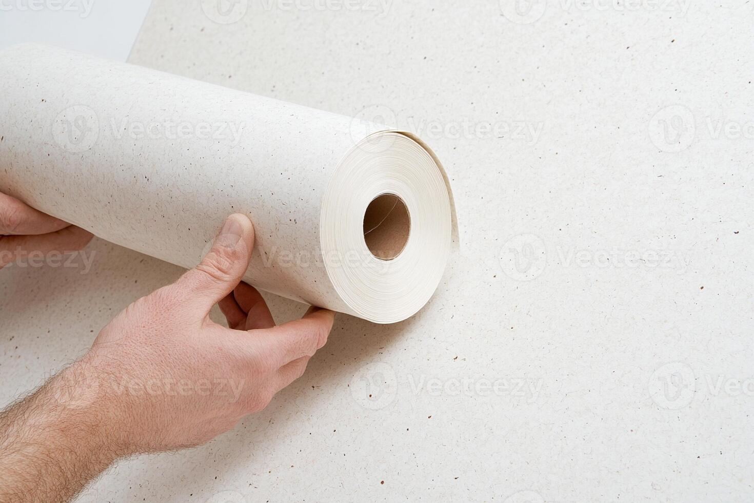 A person is holding a roll of paper photo