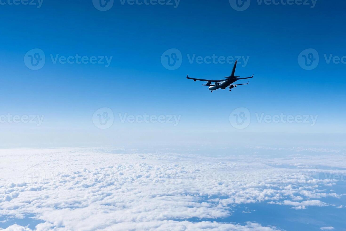 A large airplane flying over the clouds photo