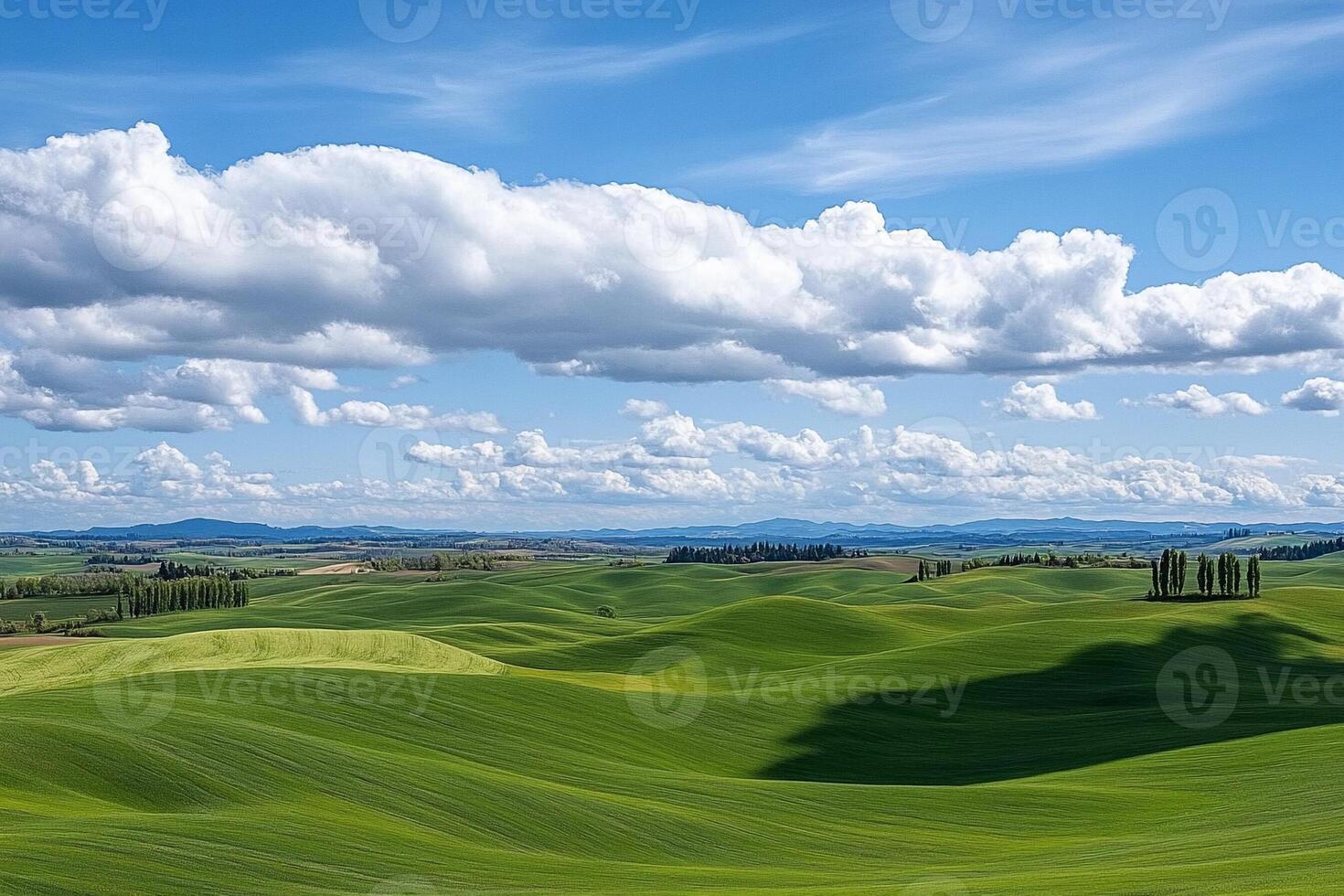 Rolling hills and green fields with clouds in the sky photo