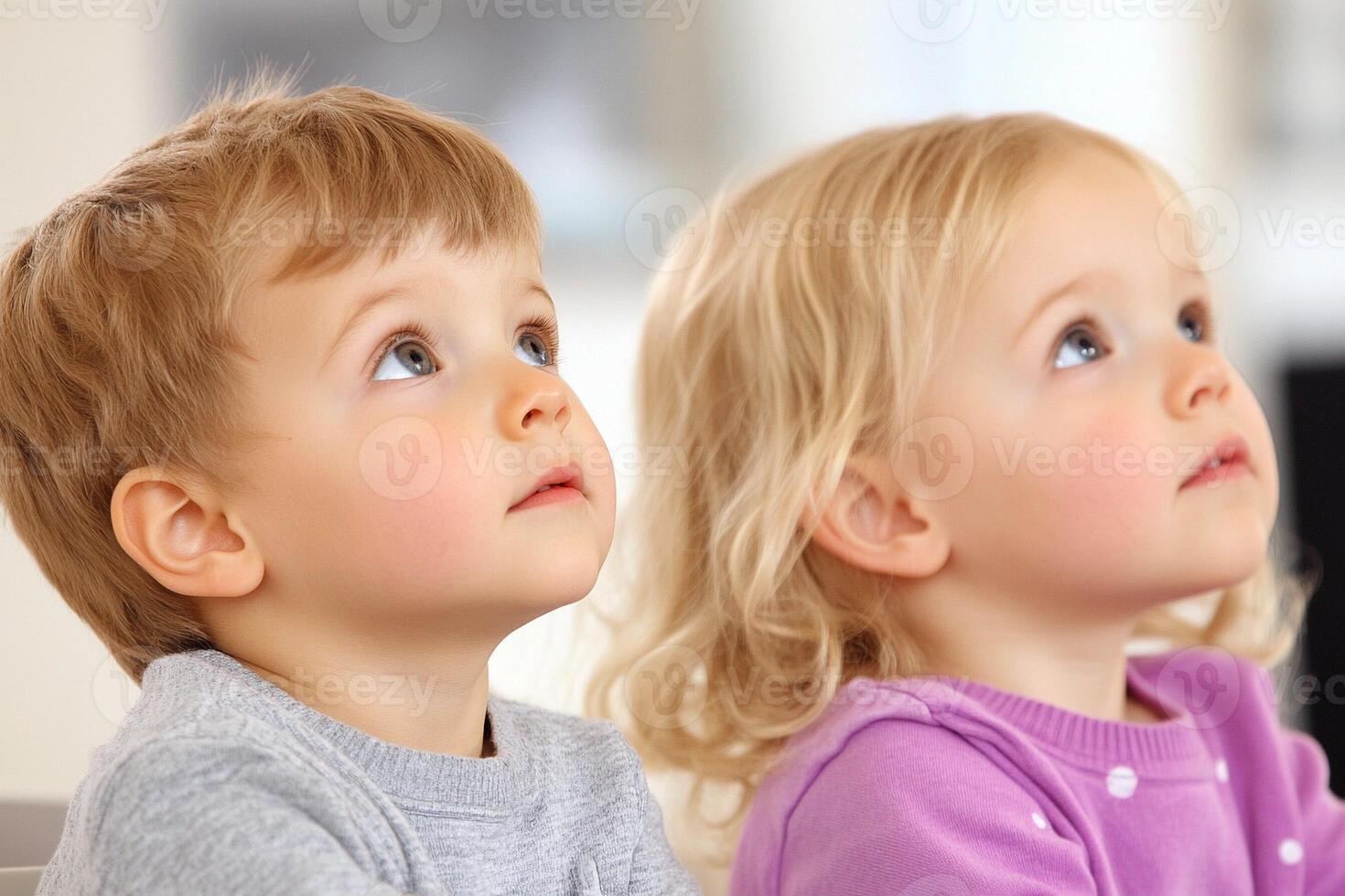 Two young children looking up at something photo