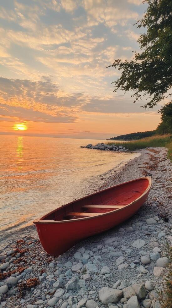 Sunset Serenity Red Boat on a Pebble Beach photo