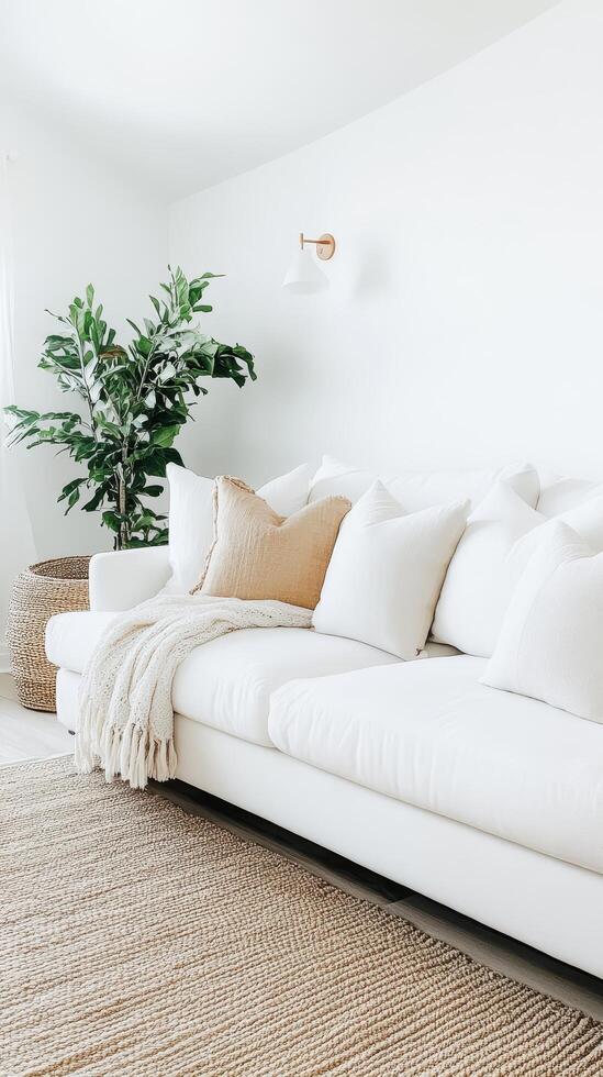 Elegant Home Interior White Sofa, Cozy Blanket, and Green Plant for a Relaxing and Minimalist Living Space with Bright and Clean Design Elements photo