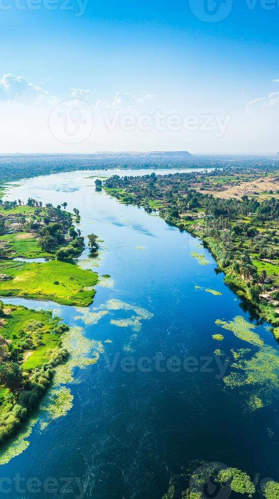 Breathtaking Nile River Panorama A Serene Aerial View of Egypt's Lifeline, Capturing the Lush Greenery and Azure Waters Under a Clear Blue Sky photo