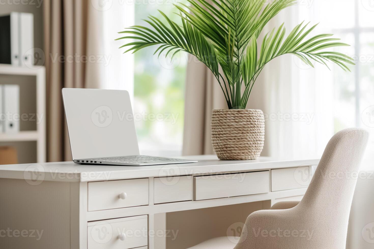 A white desk with a laptop and chair in front of a window photo