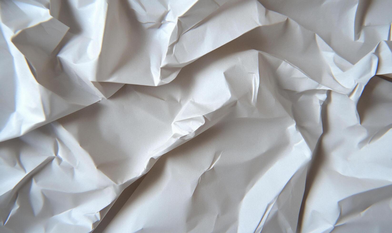 A close-up of crumpled white paper, showcasing texture and depth. photo