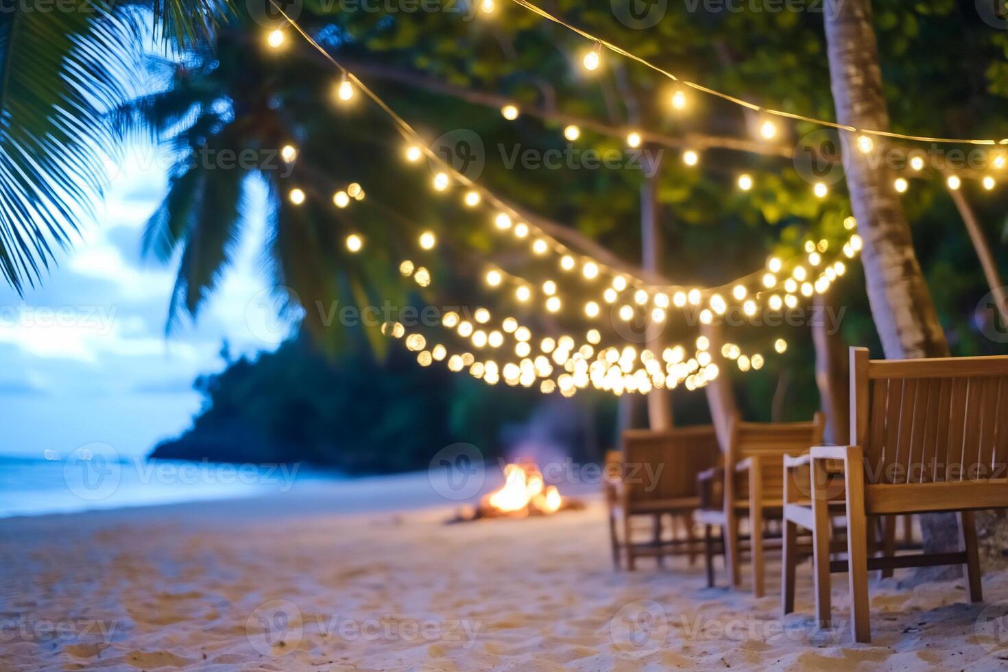 A beach with chairs and a fire pit photo