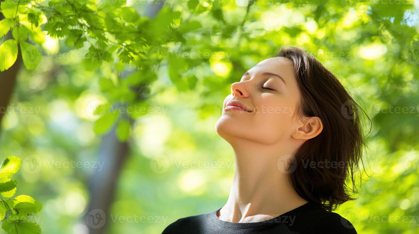 A woman is looking up at the sky while breathing deeply photo