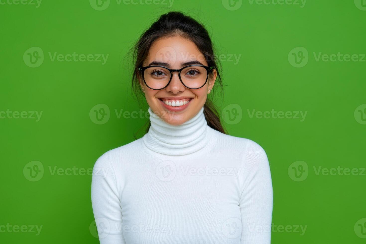 Portrait of a young woman wearing glasses and white turtle neck sweater on green background photo