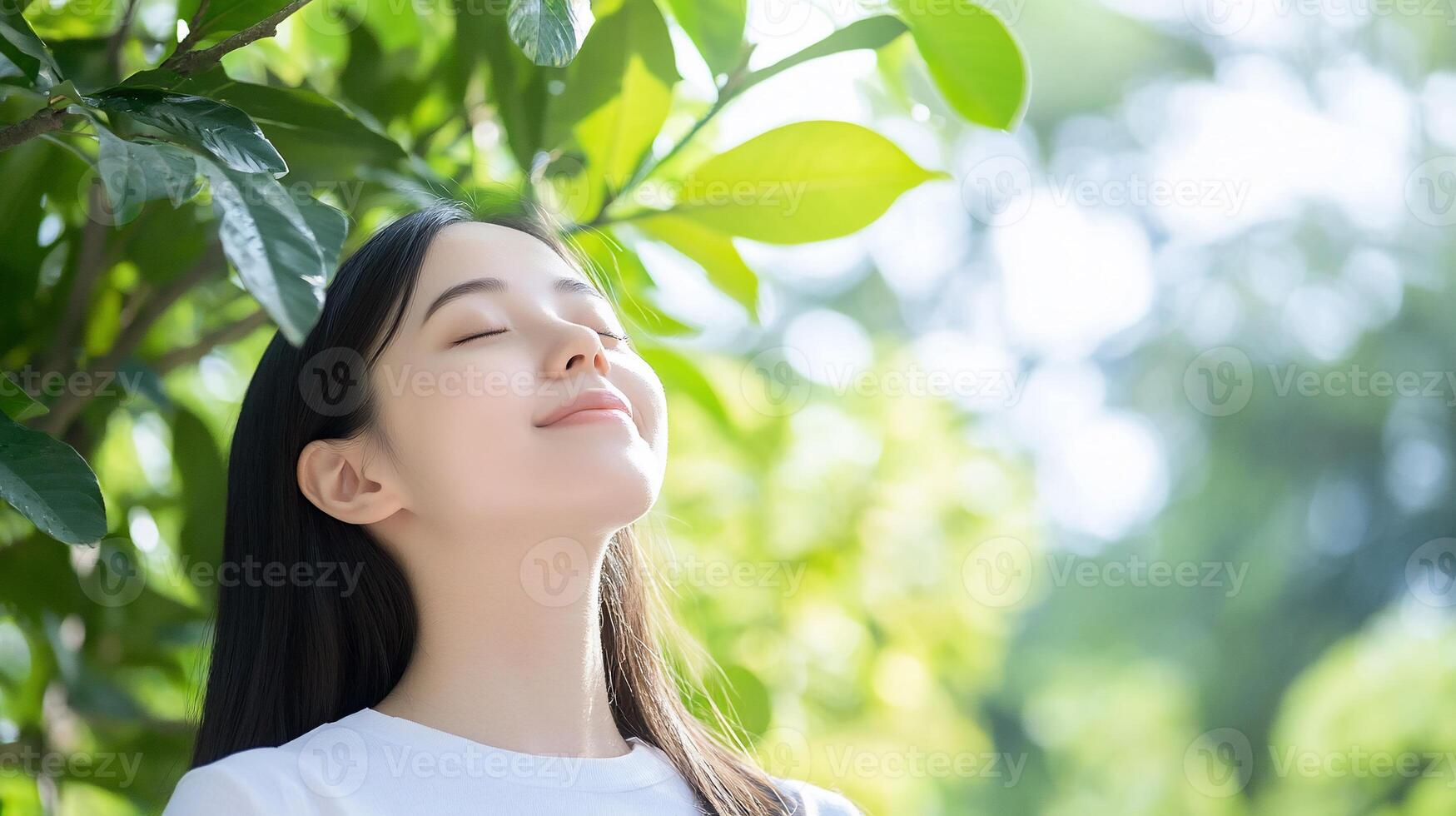 A woman is breathing deeply while looking up at the sky photo