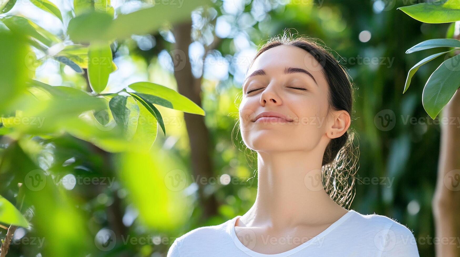 A woman is smiling while looking up at the sky photo