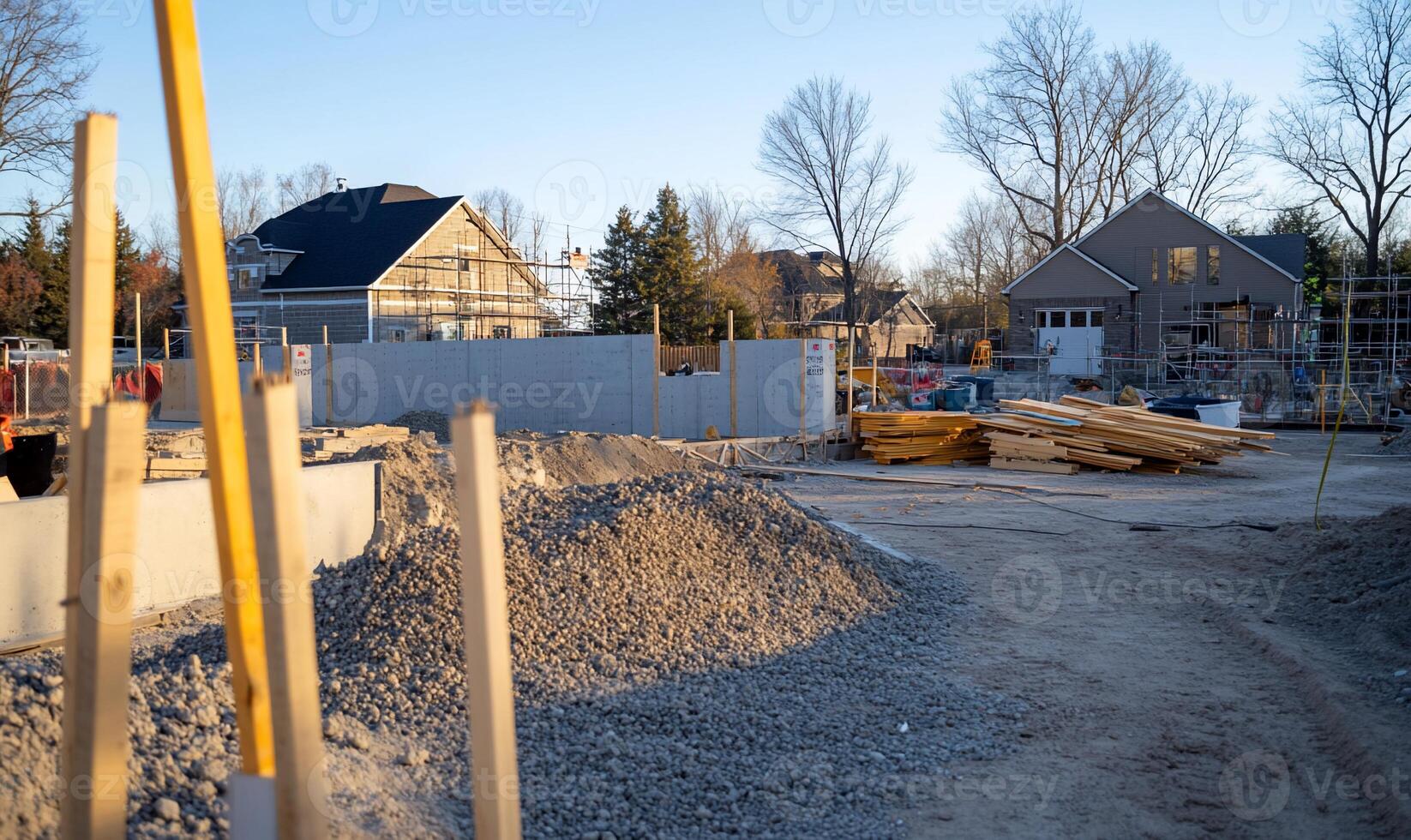 A construction site with a pile of gravel and a yellow pole photo
