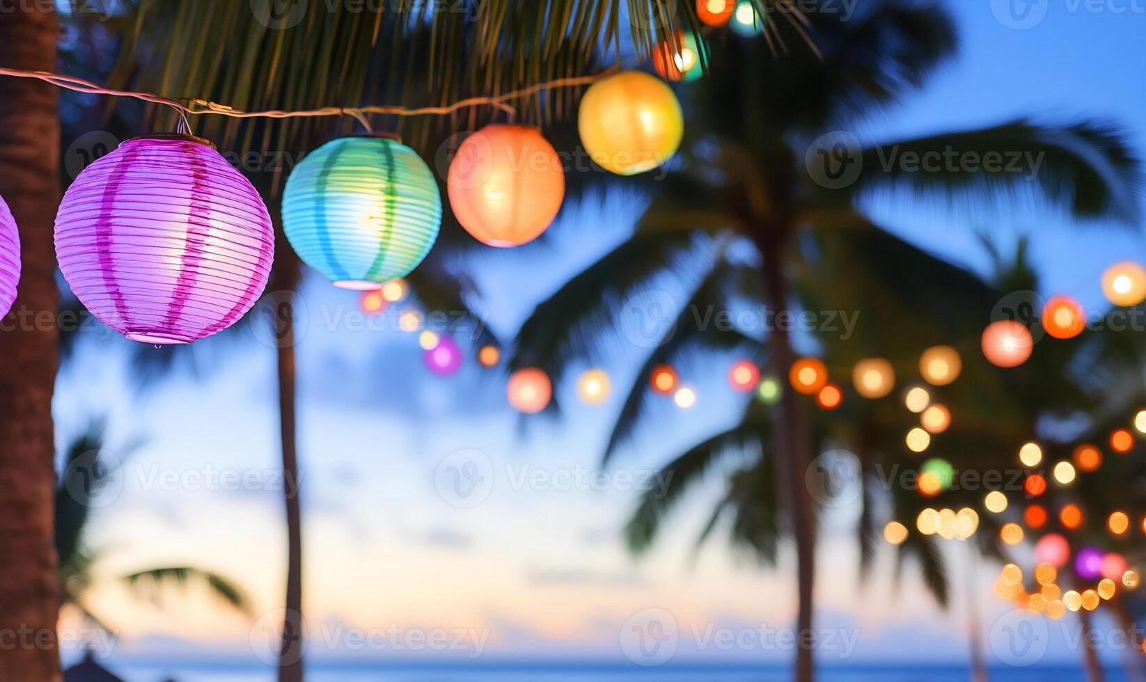 Colorful paper lanterns hanging from palm trees at the beach photo