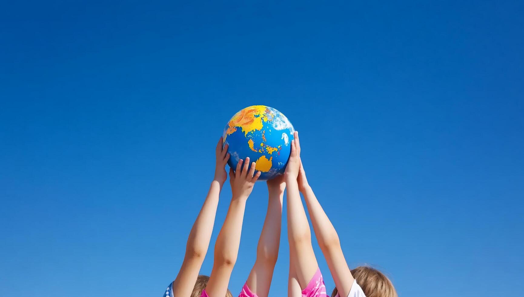 Three children holding up a globe photo