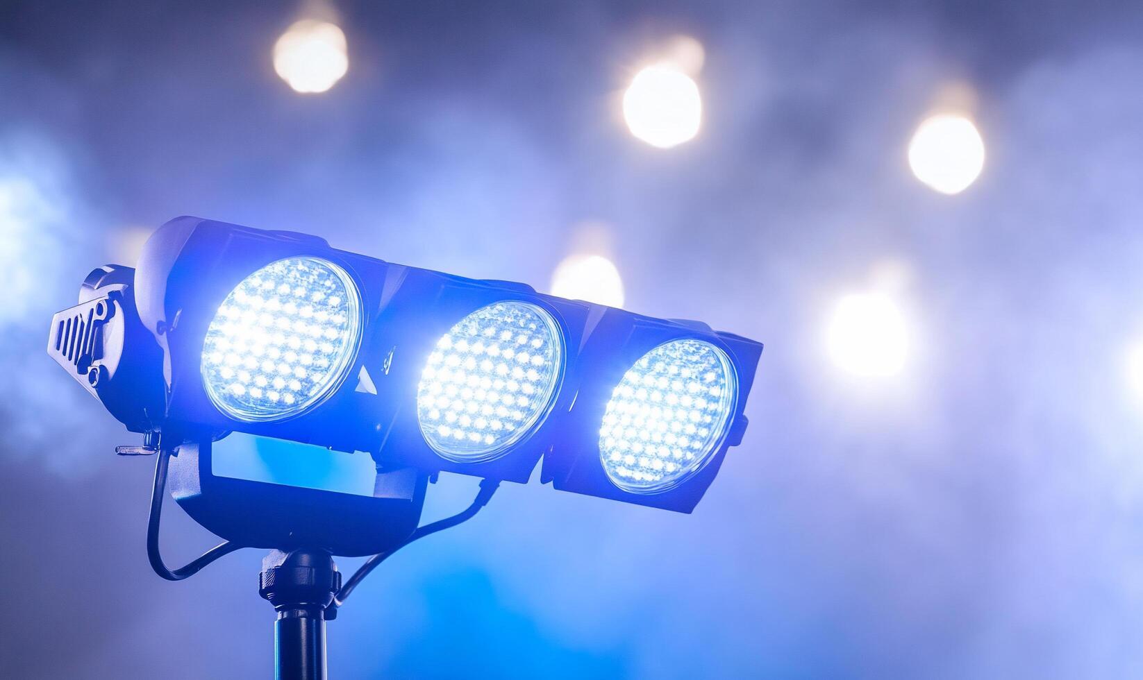 Three spotlights on a stage with smoke photo