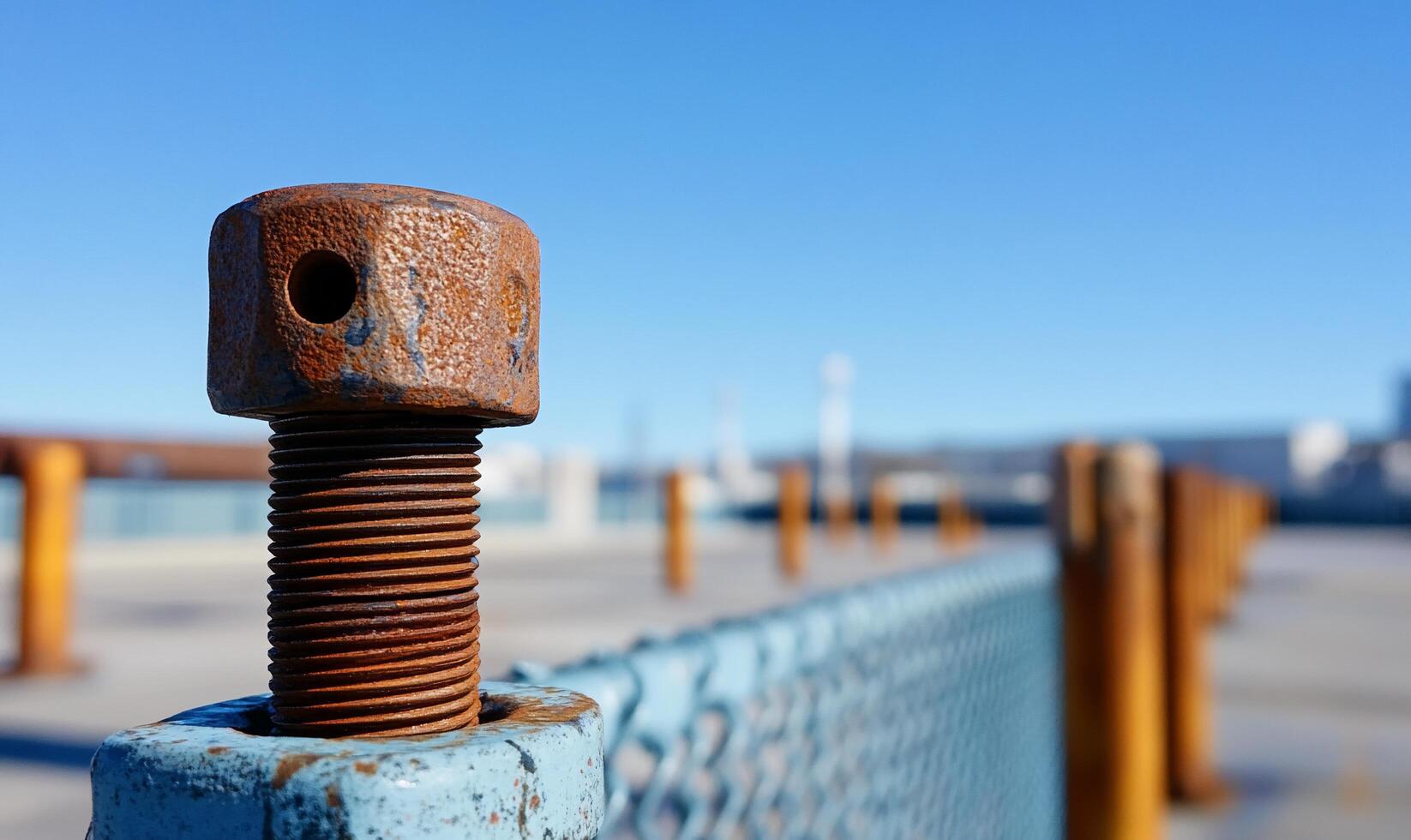 A rusty bolt on a fence photo