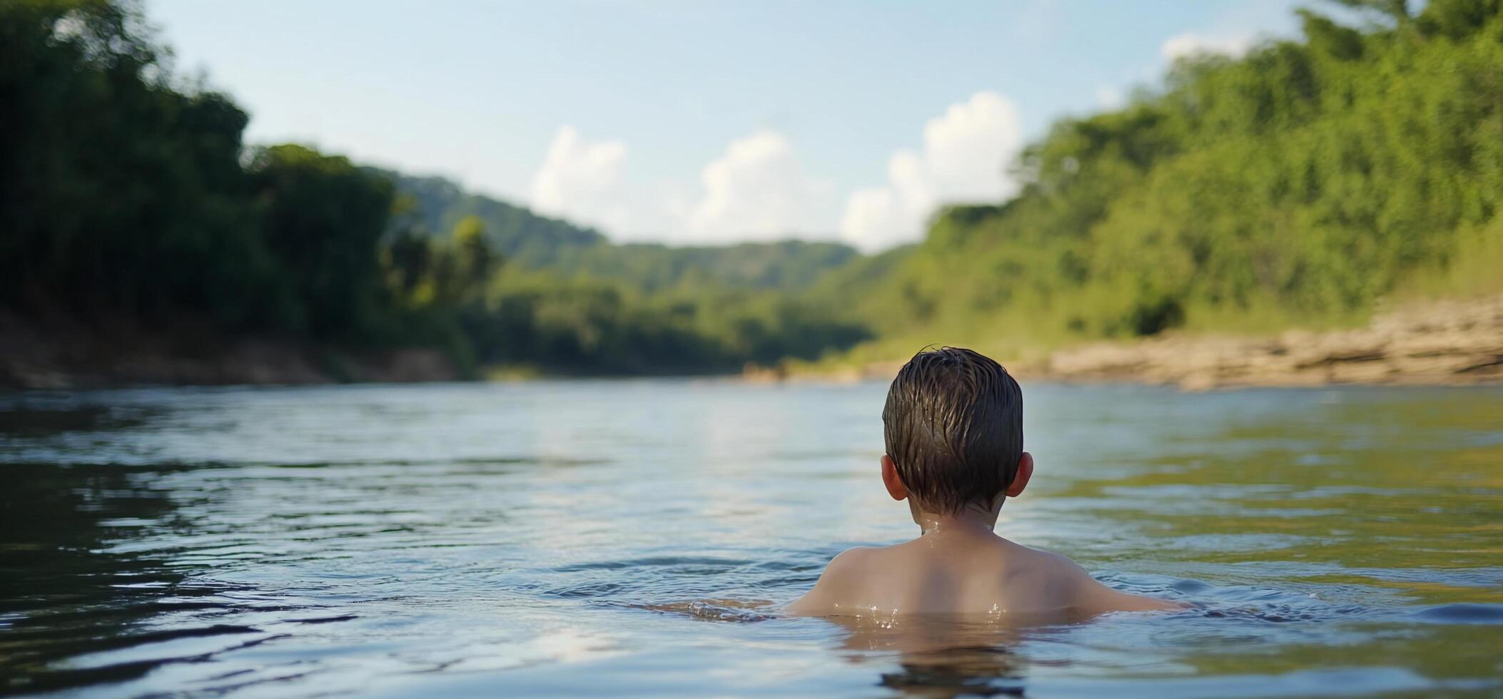 A boy swimming in a river photo