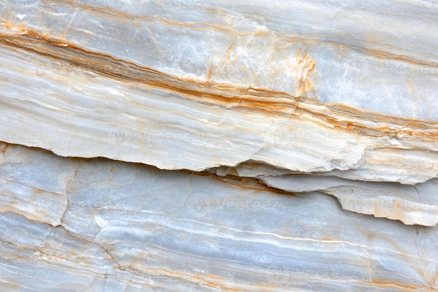 A close up of a white marble wall with orange and yellow paint photo