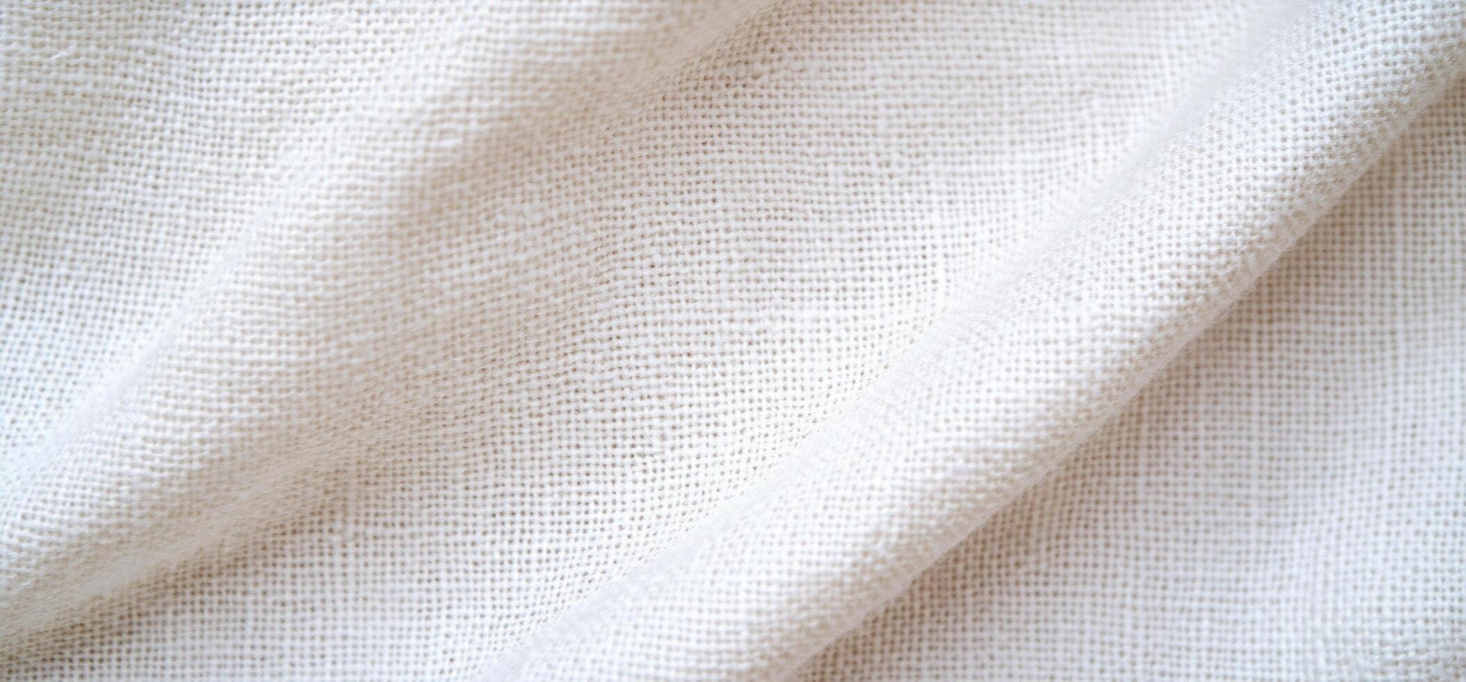 Close-up of a textured white fabric, showcasing its weave and softness. photo