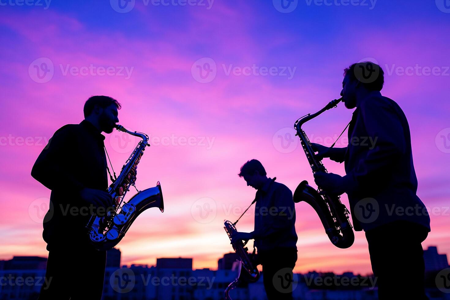 Three men playing saxophones at sunset photo
