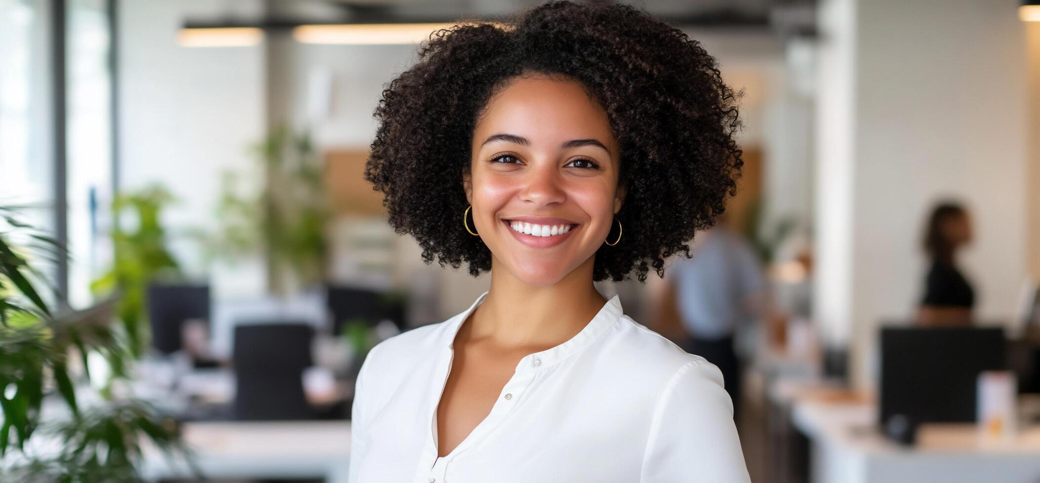 A smiling woman in a modern office environment. photo