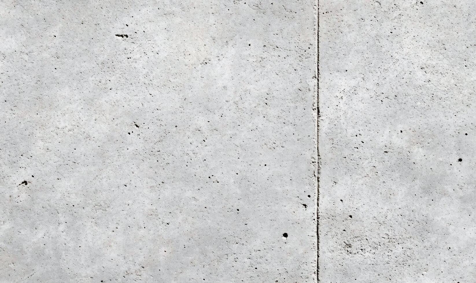 A close-up view of a textured concrete surface with subtle variations. photo