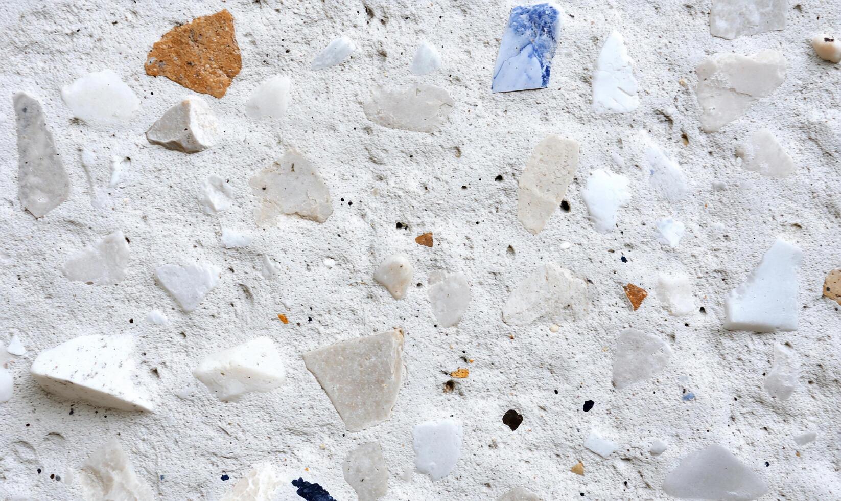 Close-up of a textured surface featuring various stone fragments. photo