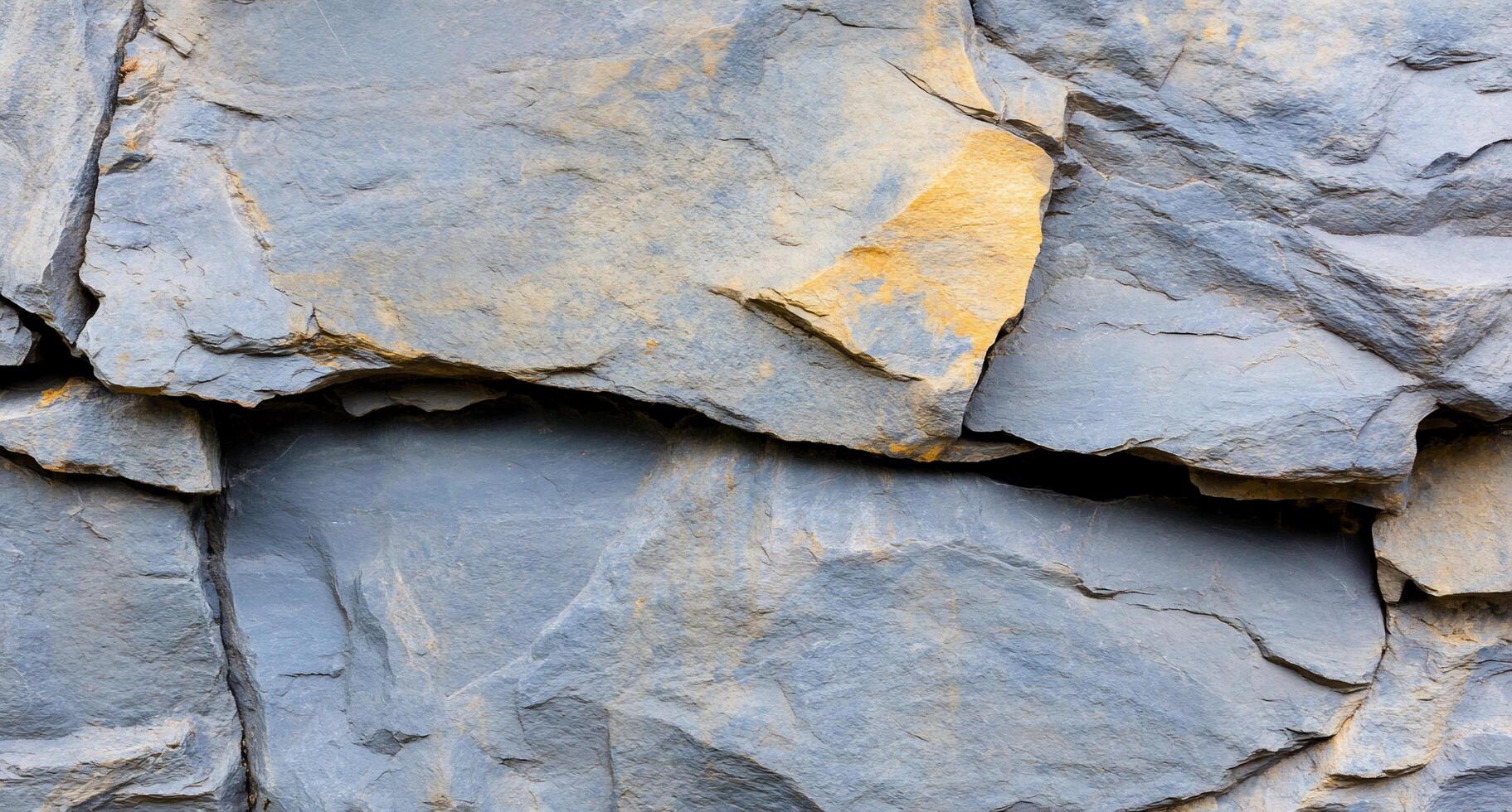 Close-up of textured slate rock surface with natural color variations. photo