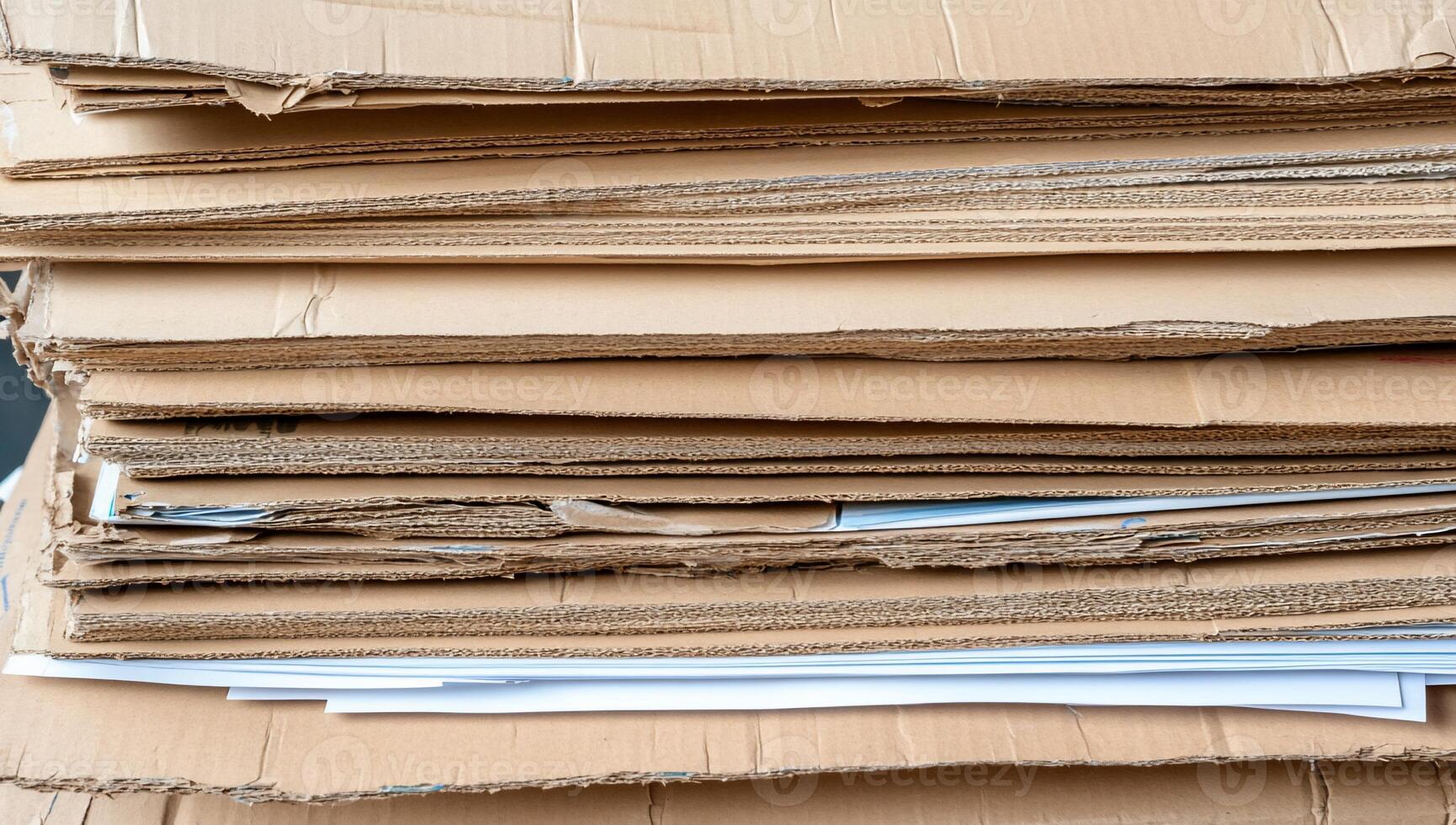 A stack of cardboard boxes with papers on top photo