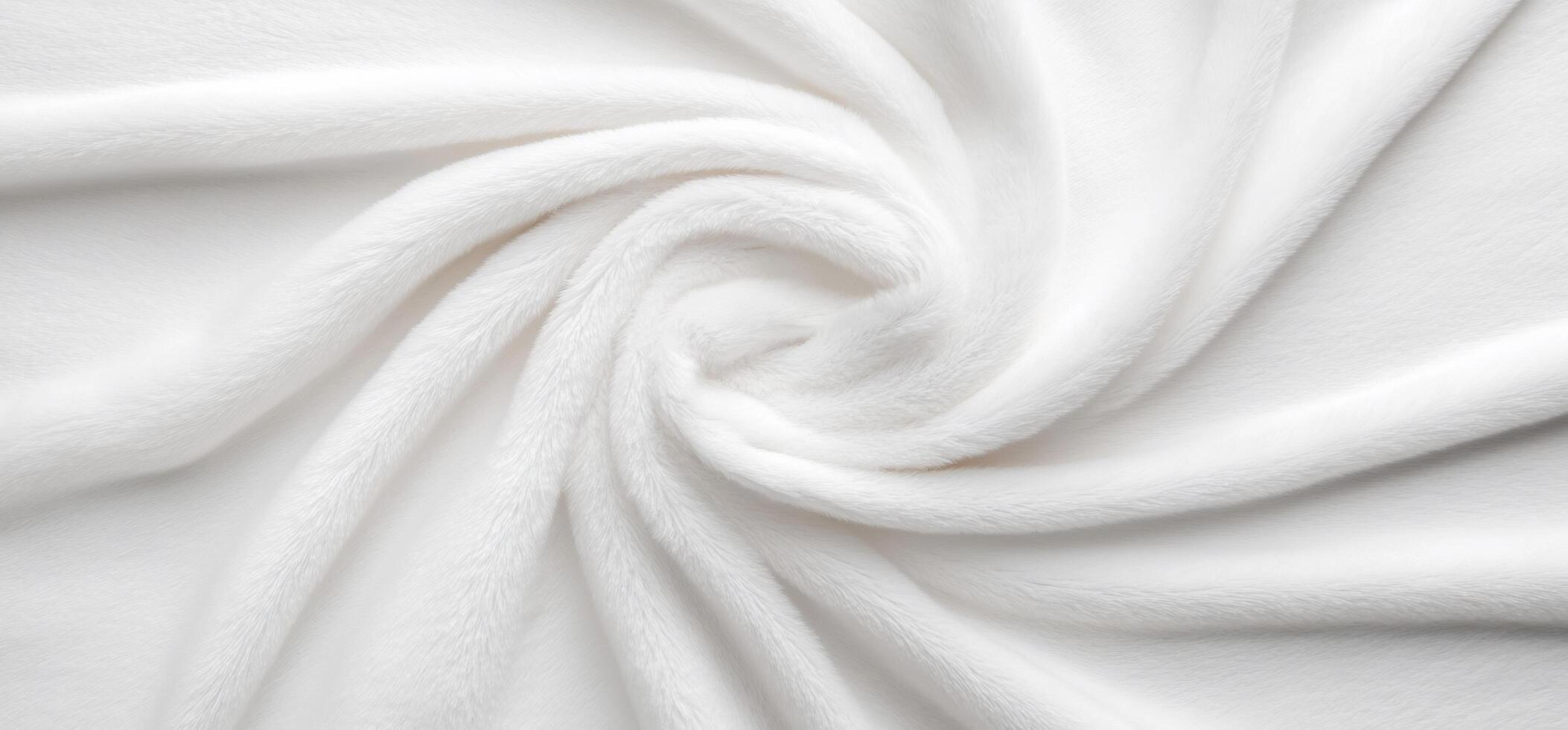 A soft, white blanket elegantly arranged in a spiral pattern. photo