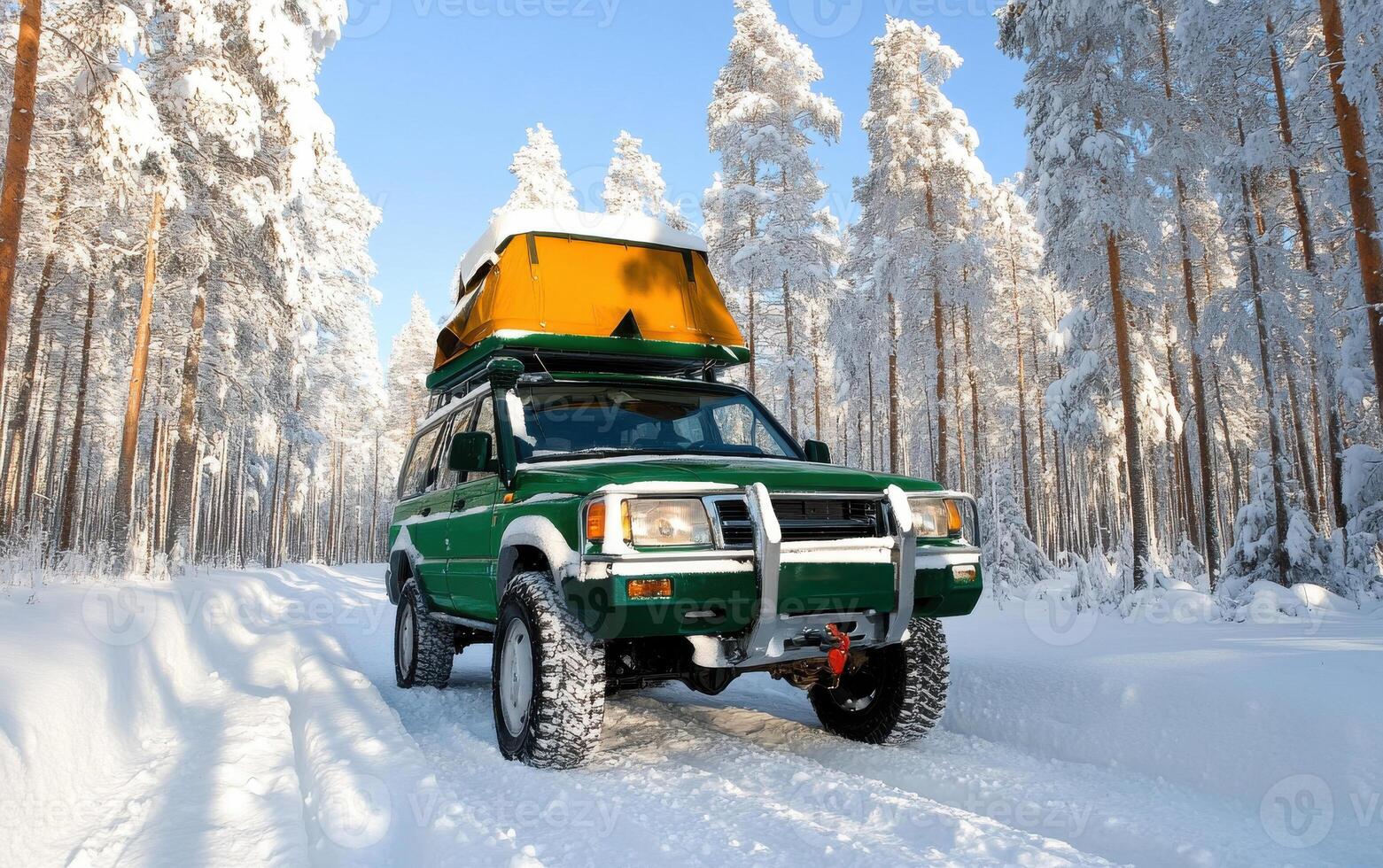 Off-roading camping adventure in snow-covered forest with a green vehicle and roof-top camper photo